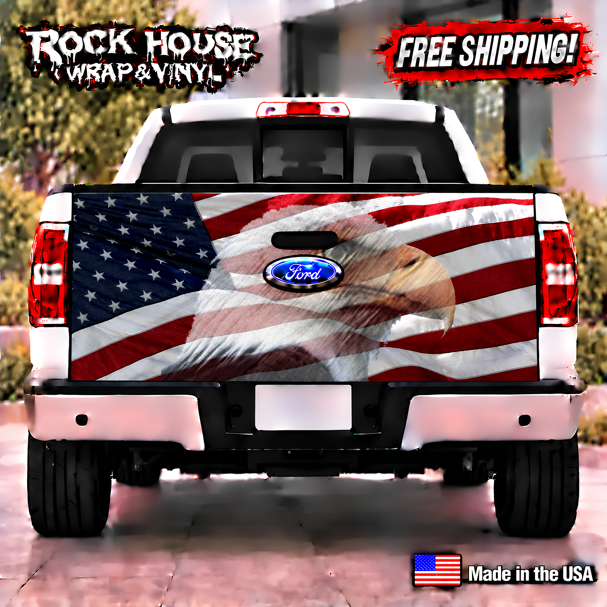 a white Ford truck with a large American flag design on the rear. The truck is parked on a street, and there is a "Rock House Wrap & Vinyl" advertisement above it. The truck has a "Ford" logo on the trunk, and there is a "Made in the USA" label at the bottom of the image.