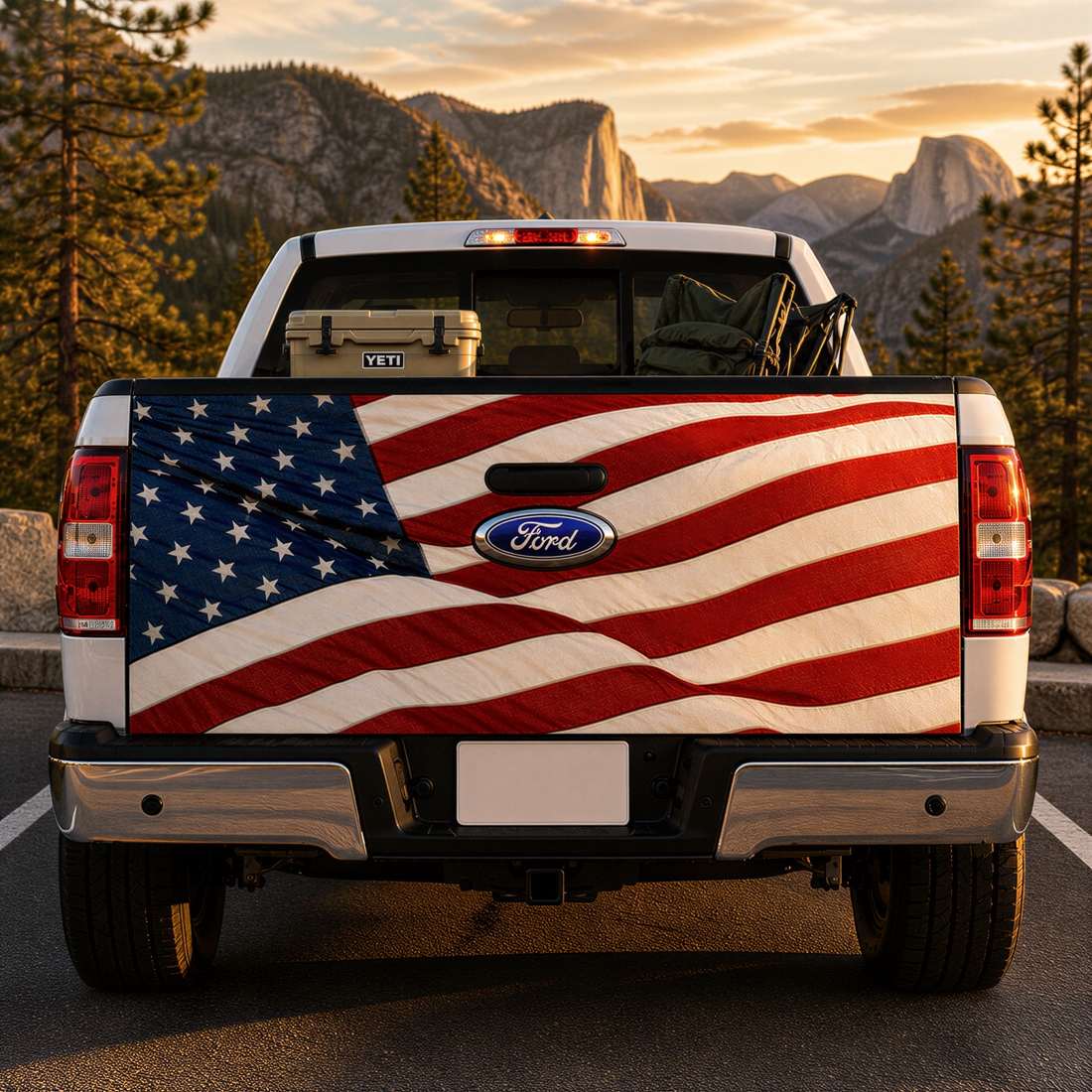 a white Ford truck with an American flag decal on the rear.