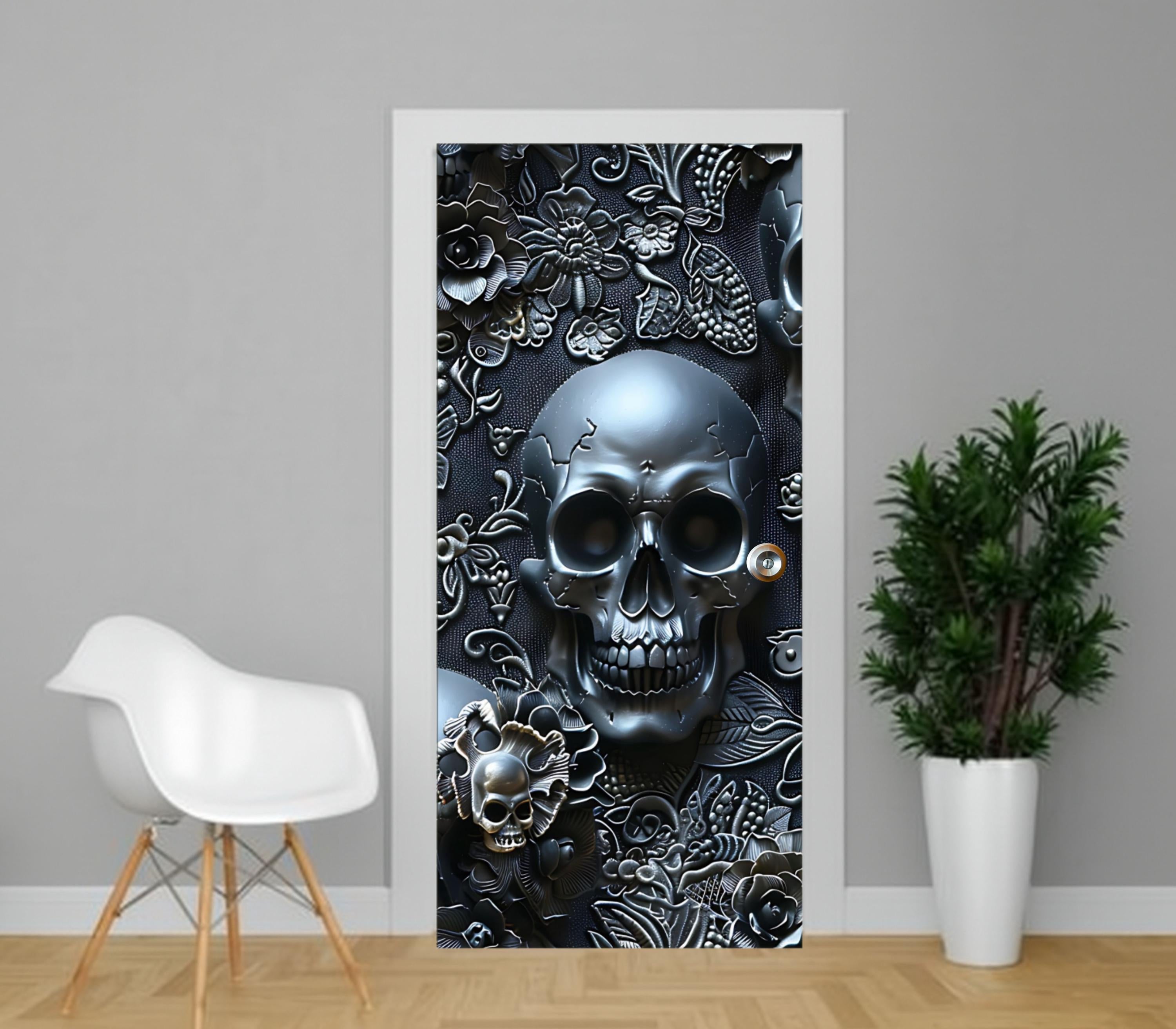 a door with a large, intricate skull design on it, surrounded by floral and leaf patterns. There is a white chair and a potted plant in the foreground, and the background is a gray wall.