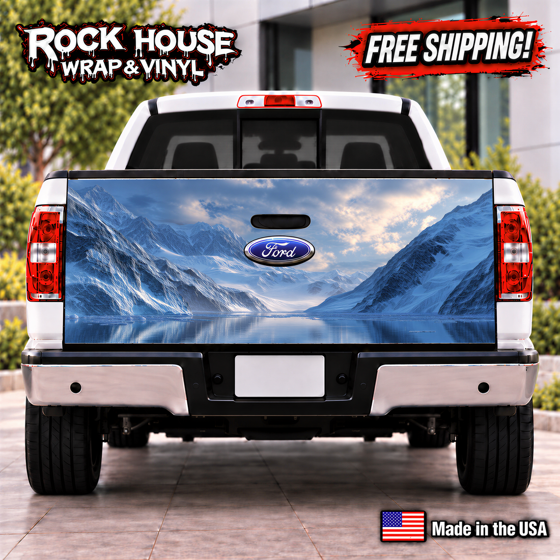 the rear of a white Ford truck with a large, detailed decal of a mountain landscape on the trunk. The truck is parked on a paved surface, and there is a sign that reads "Rock House Wrap & Vinyl" and "FREE SHIPPING!" indicating that the truck is being advertised for sale.