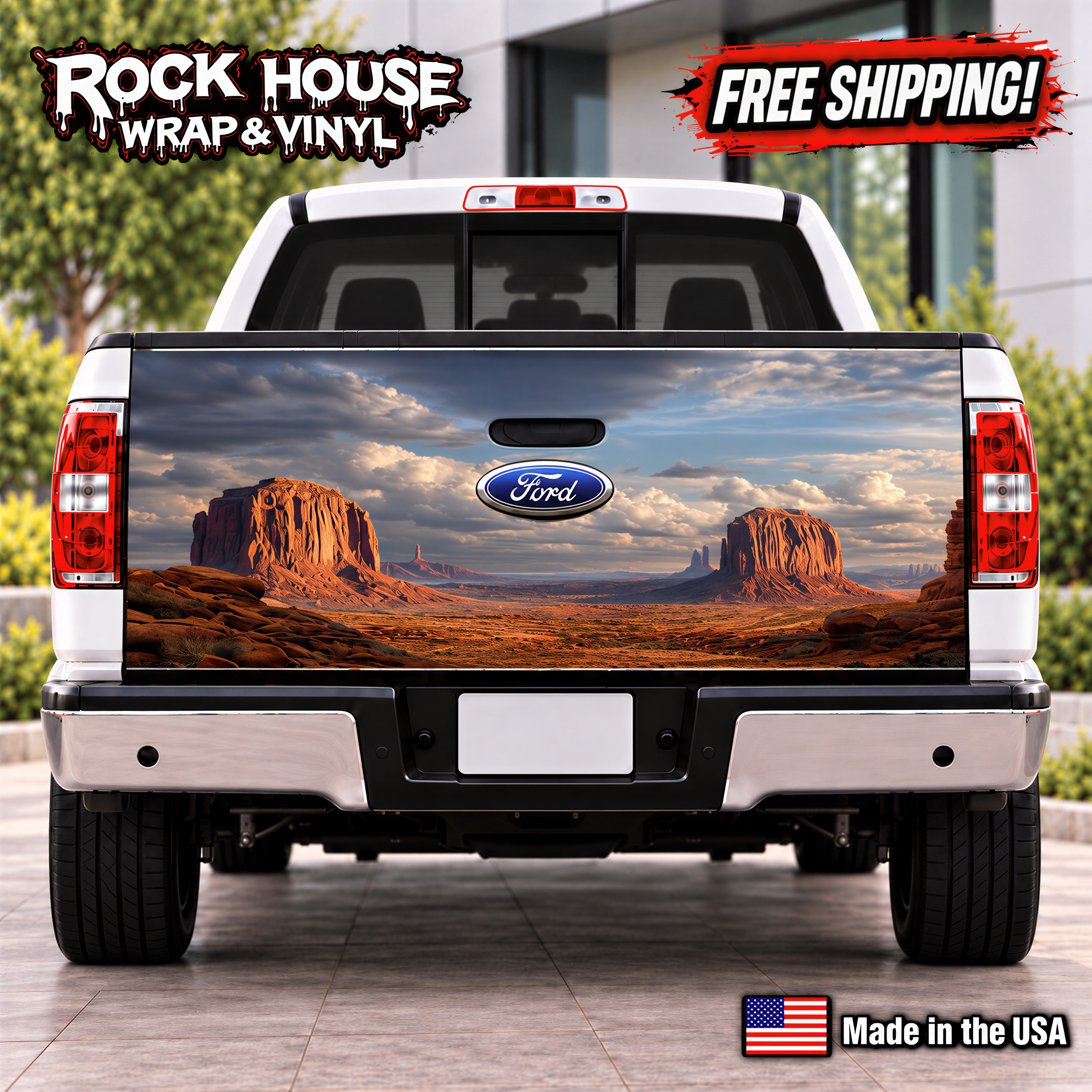 a white Ford truck with a large rear wrap depicting a desert landscape with mountains in the background.